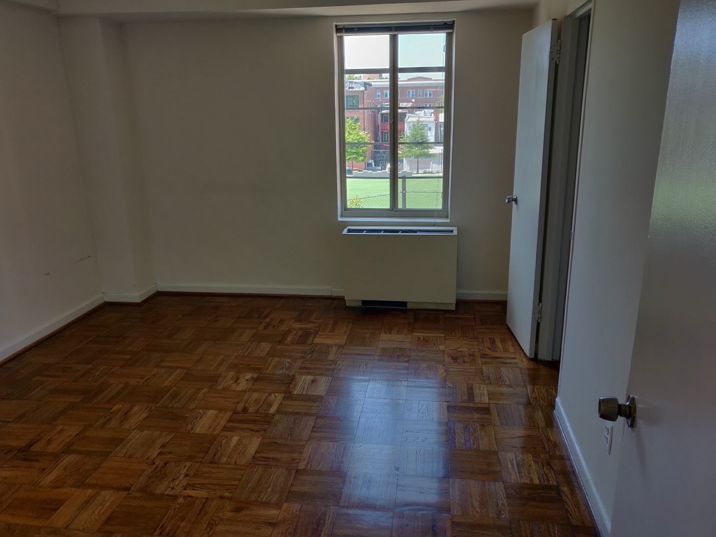 Apartment bedroom with parquet wood flooring